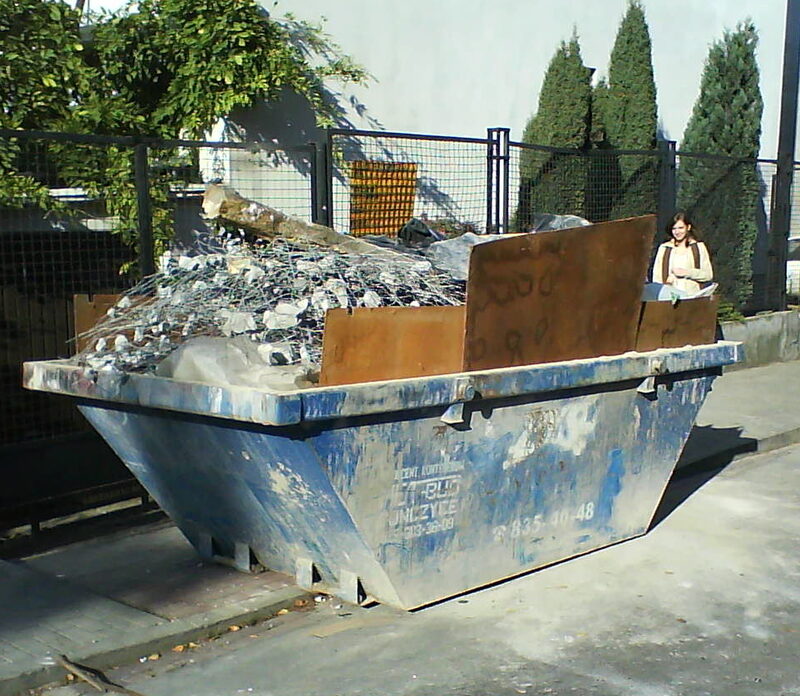 Blue 2 cubic metre mini skip bin heaped with scrap metal and timber offcuts